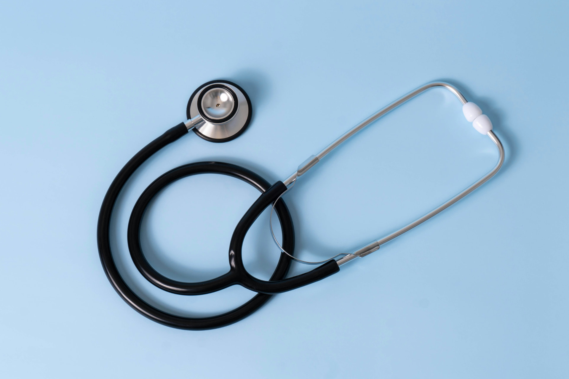 Stethoscope resting on a light blue background