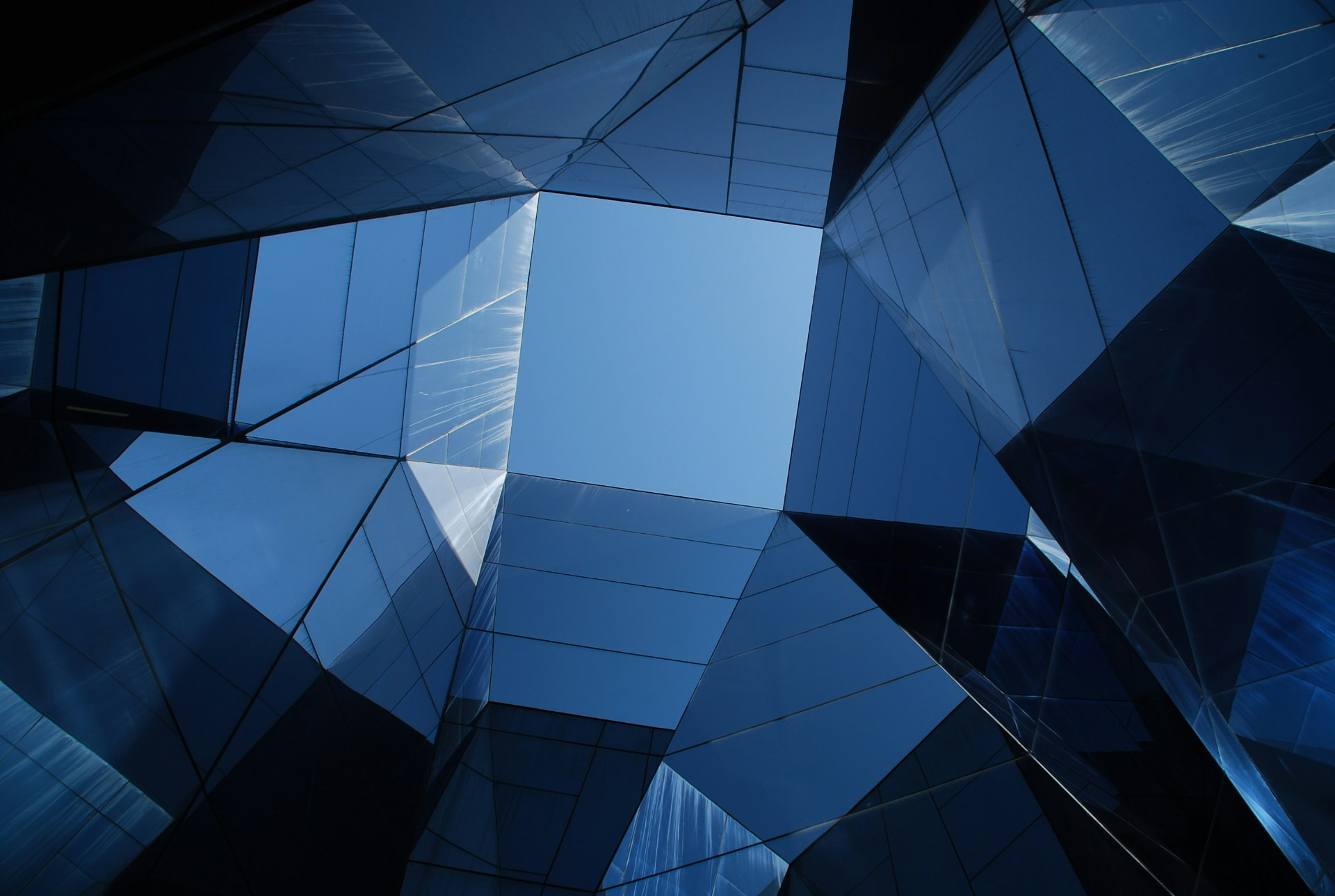 Abstract blue glass facade of a modern professional services building